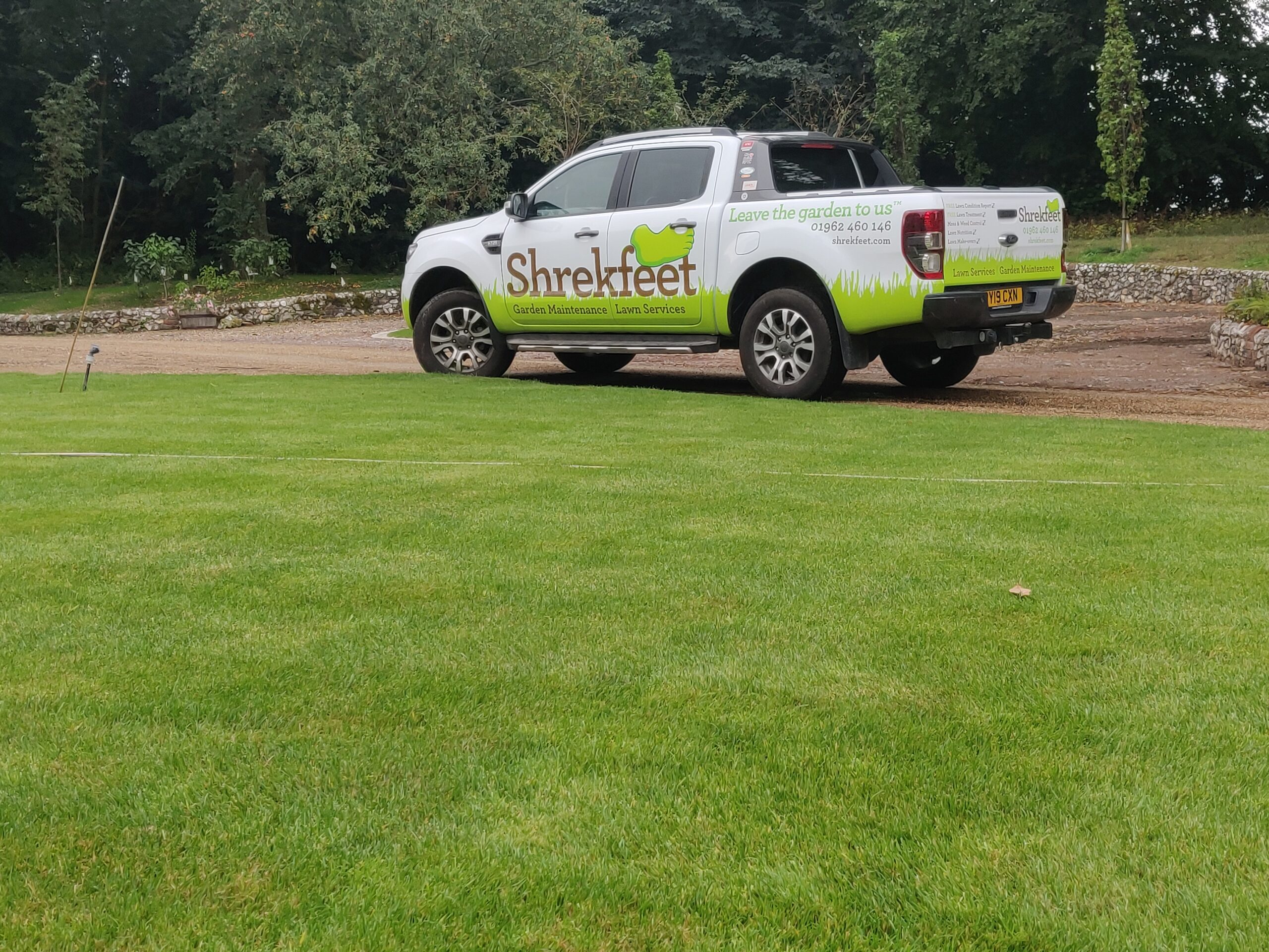 Shrekfeet technician applying professional weed treatment to a lawn