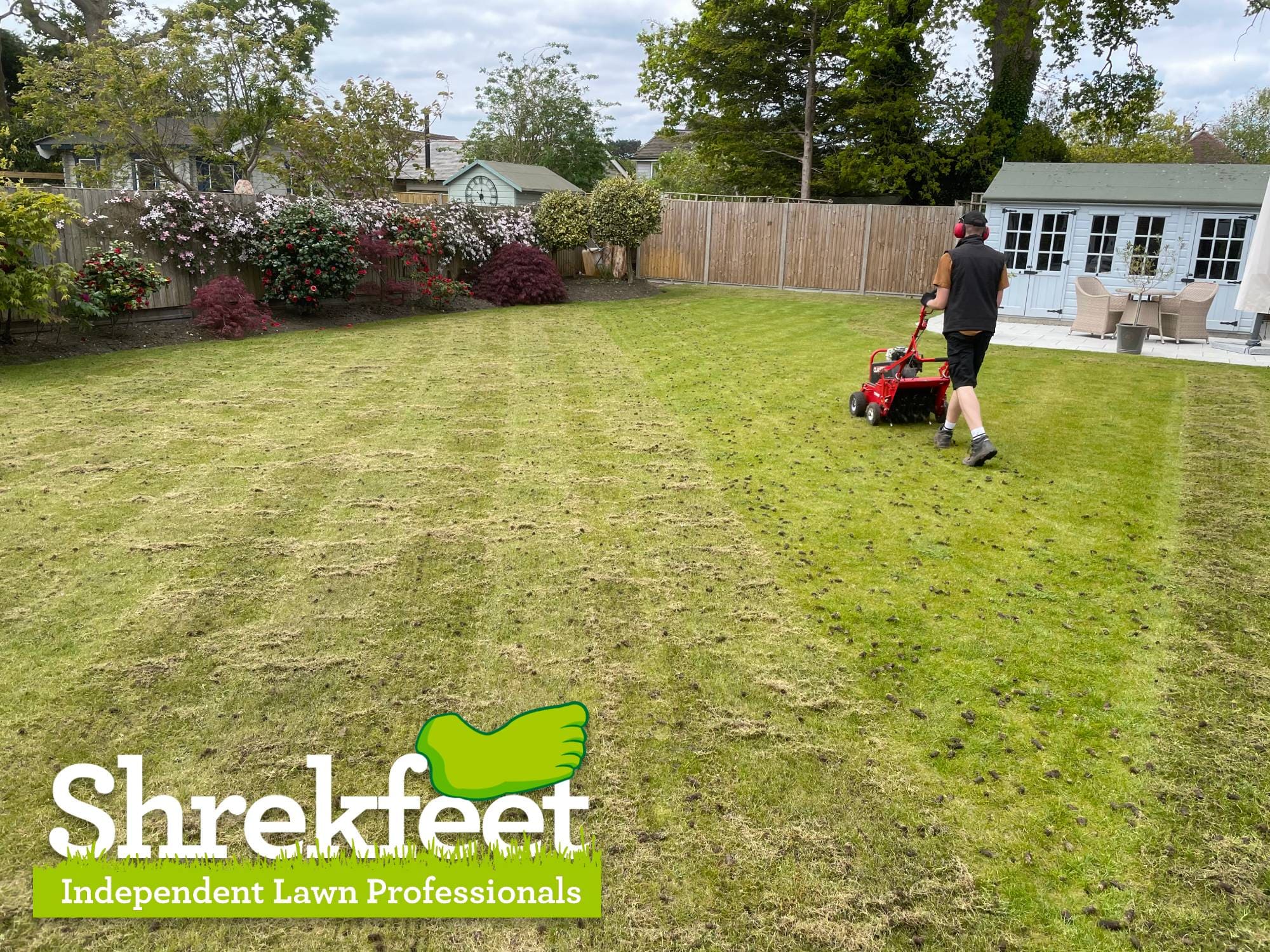 Hollow-tine aeration being carried out on a lawn